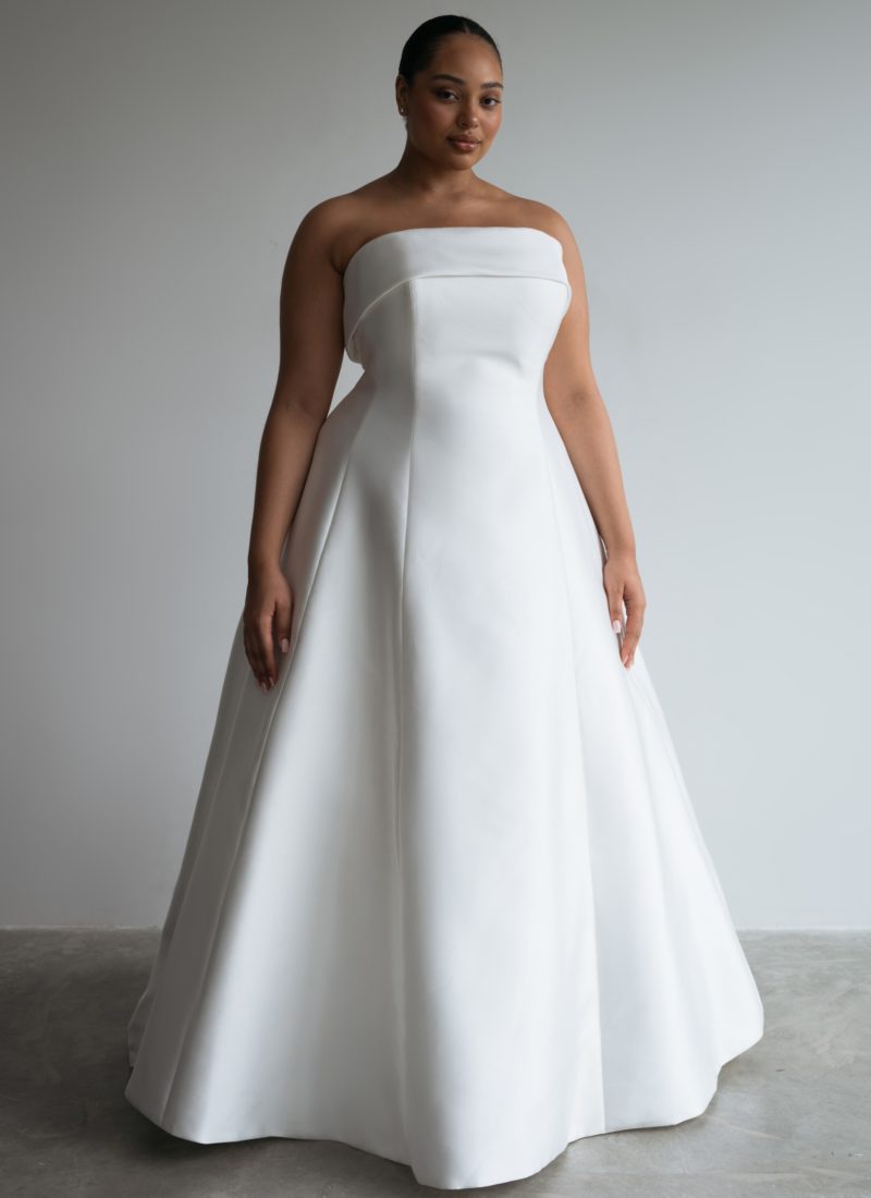 Modern simple bridal gown on a plus size model