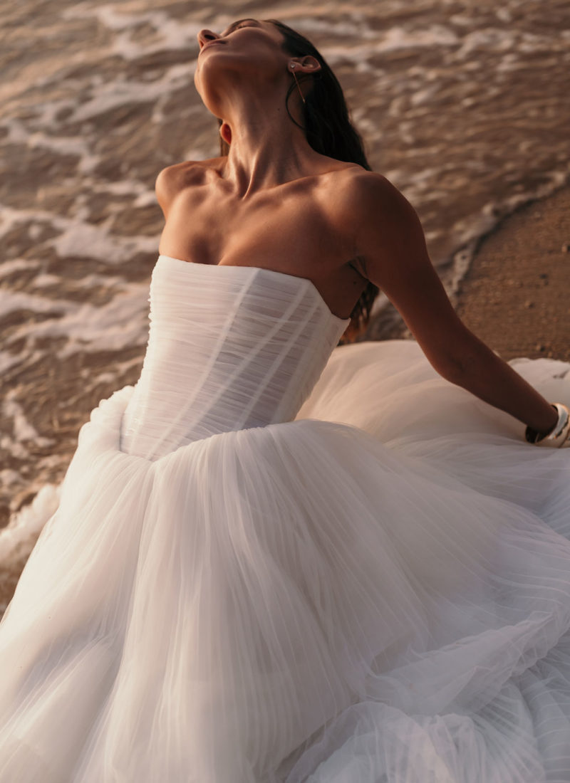 Model wearing a modern tulle wedding dress by Alena Leena