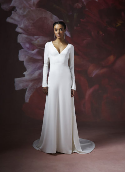 model wearing a long sleeve crepe wedding dress